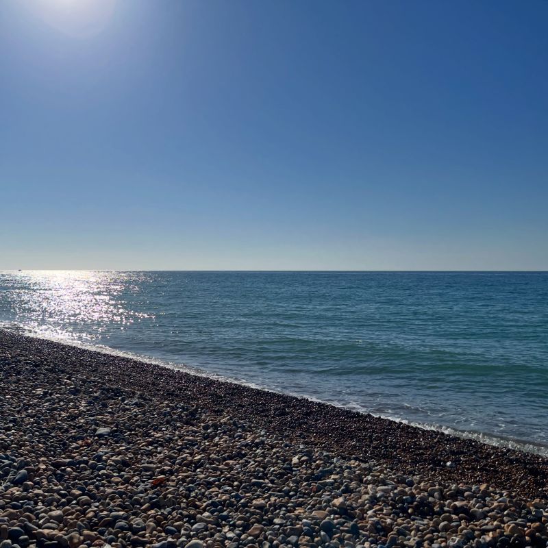The calm blue water of rocky Brighton beach on a sunny day